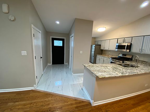 Kitchen, front door, from living/dining room.