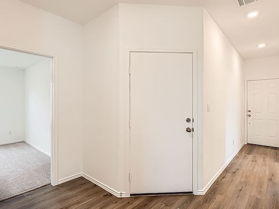 Entry hallway looking back at the front door and garage door