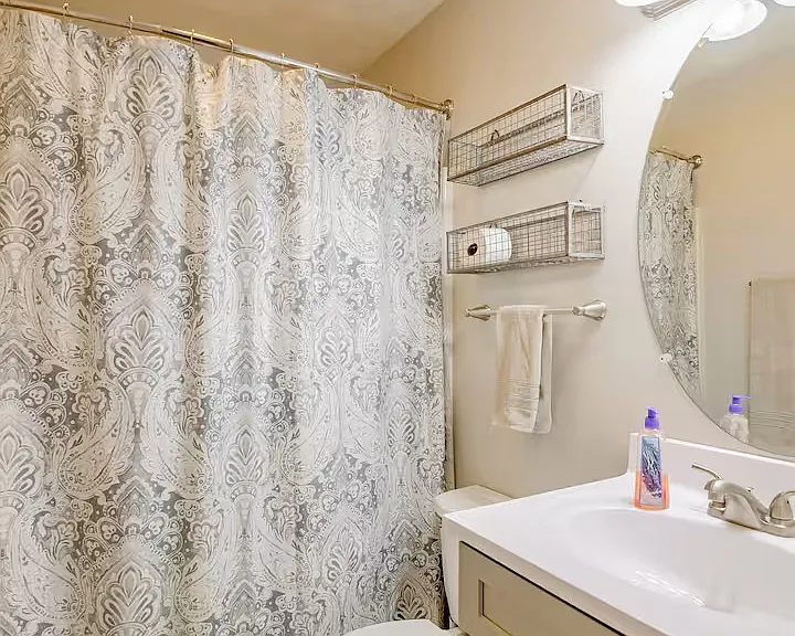 Full bath upstairs between bedrooms. Shower/tub combo. Updated sink, vanity and toilet. Tiled floor.