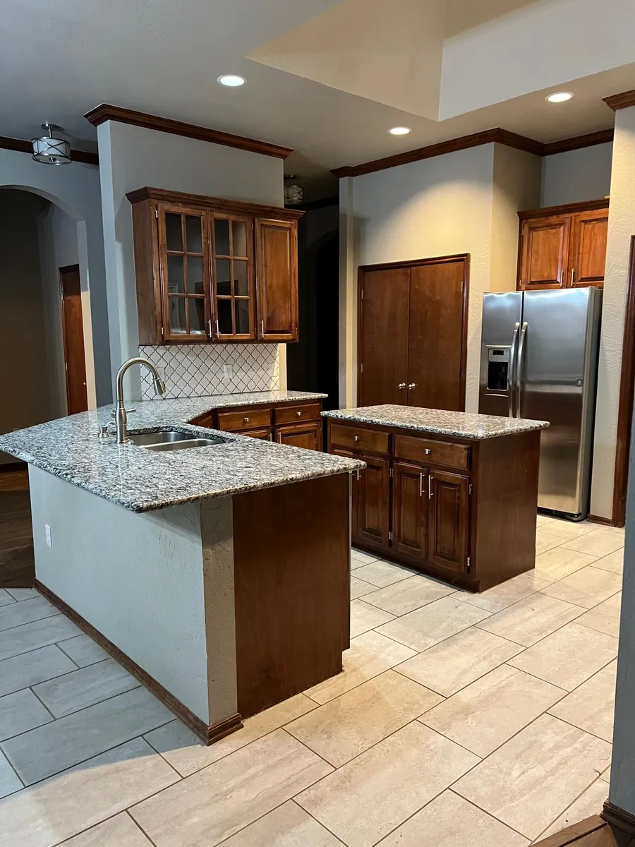 Kitchen with lots of countertop space, an island with electric outlets, double pantries, granite and updated stainless steel appliances. Huge skylight and high ceilings! - 12513 S Youngs Pl