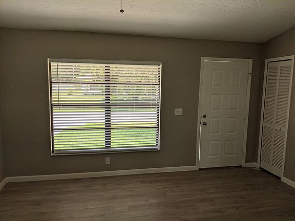 Living room has coat closet & double window