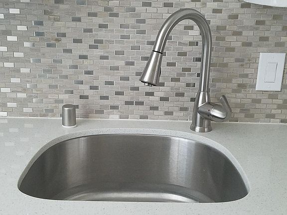 SS sink with garbage disposal and full back splash