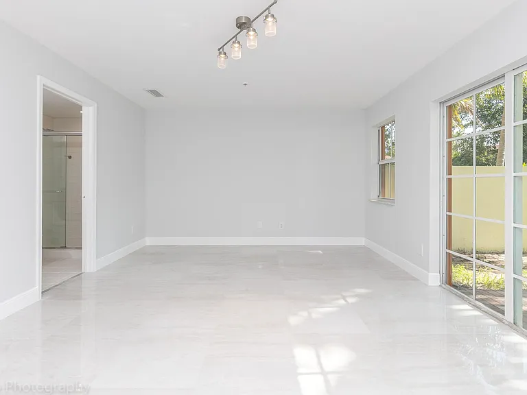 Large bedroom on 1st floor with sliding doors to back yard