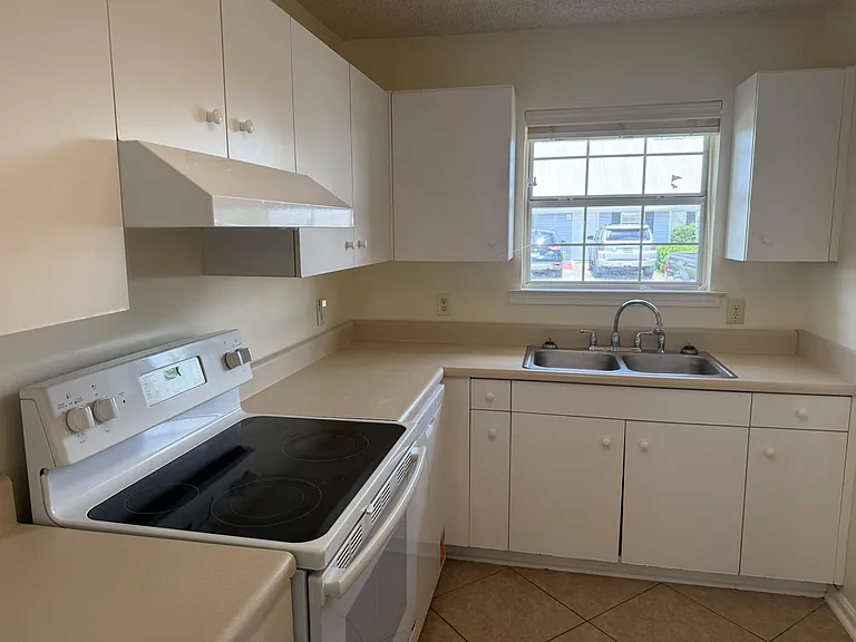 Kitchen aluminum double sink faces the driveway/street area. Kitchen faucet has a separate sprayer to make washing dishes easier.