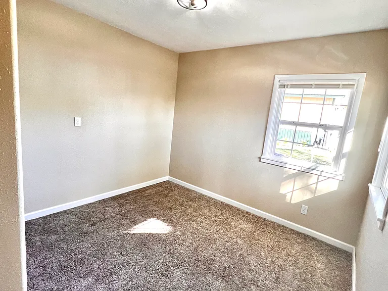 Corner bedroom, closet and door to living area