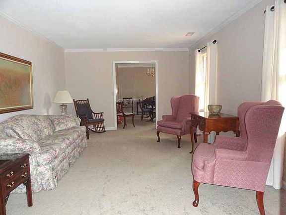 The large living room with natural light can be formal or casual