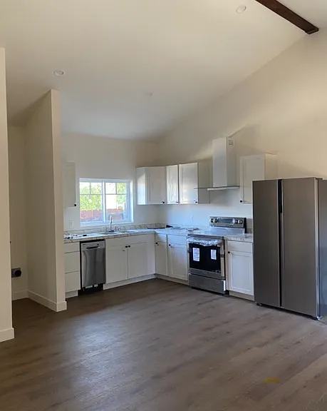 view of kitchen. To the left is the laundry area. Will come with stacked washer/dryer