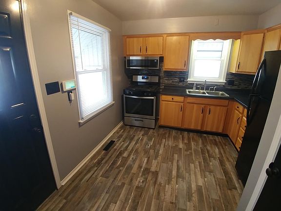 Oak Cabinets with new flooring, counter top and kitchen appliances.