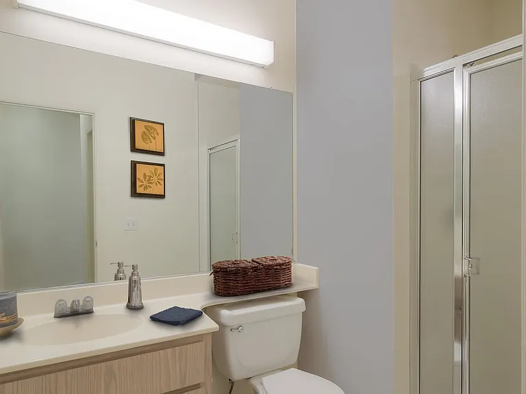 Classic Package I bath with light oak cabinetry, white laminate countertops, and hard surface flooring