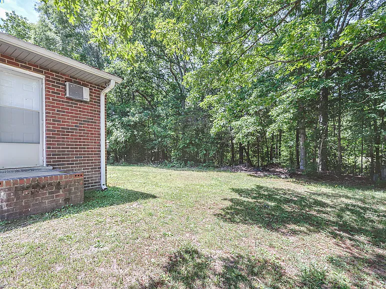Side of the yard with a pedestrian door