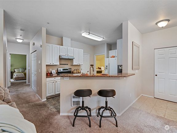 Come keep the cook company as you relax here! Lots of cabinet space and a door (to the left of the photo) that leads to a nice-sized pantry!>