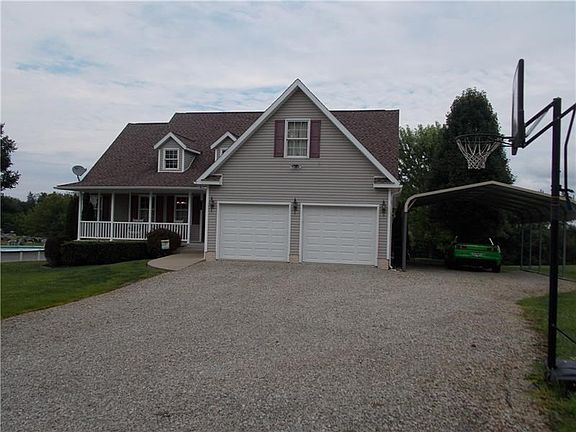 Two car garage with an extra car port on the side.  Just one step up to this single level home.
