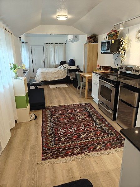 View from rear of cottage (full size bed and carpets for display purposes only and not included in rental).