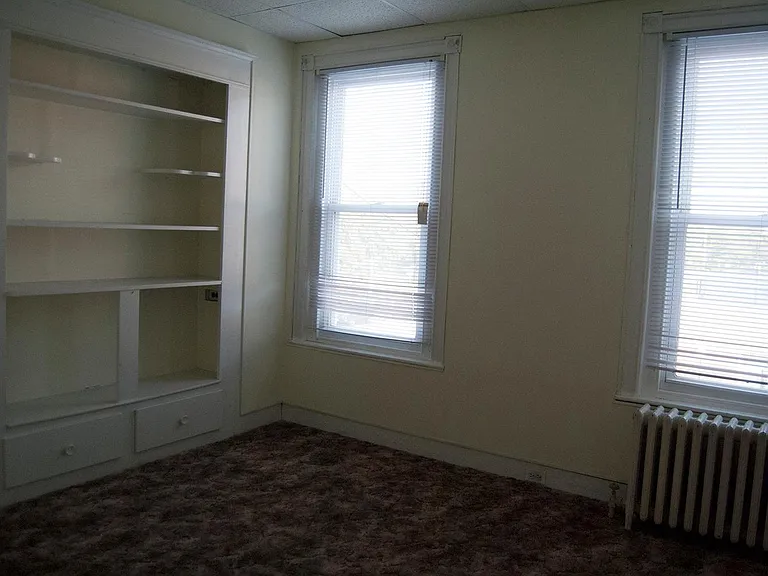 Living room includes built in bookcase.