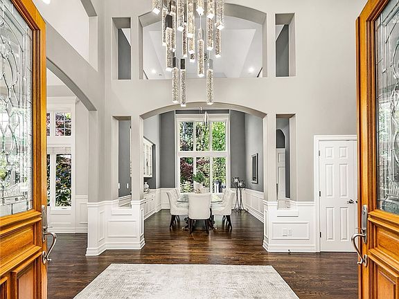 Dramatic entry way with cathedral ceilings and designer lighting