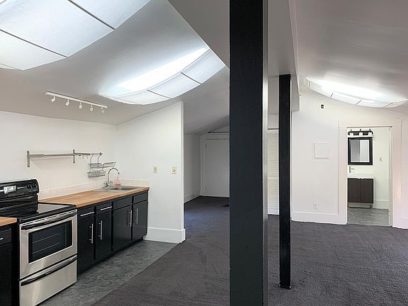 open plan living room / kitchen - view from bedroom