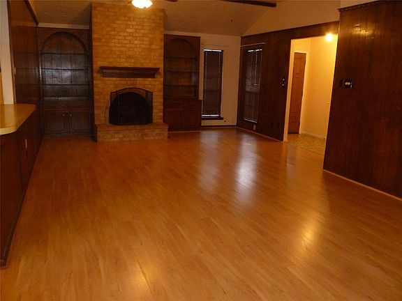 Spacious & Comfortable Family Room! Light Wood Laminate Flooring. High Beamed Ceiling.