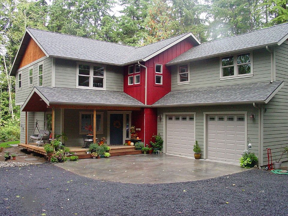 A covered porch welcomes you, along with a concrete parking
