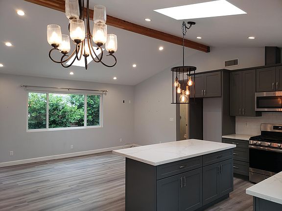 Open concept living room/kitchen. The skylights give lots of natural light and beauty.