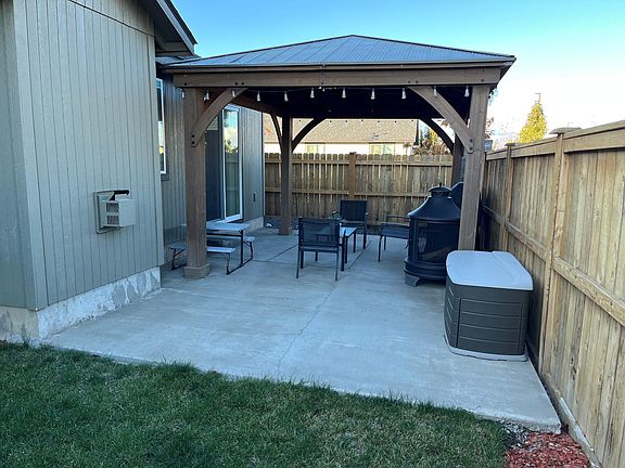 fenced back yard with gazabo