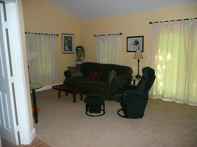 LIVING ROOM WITH SLIDING GLASS DOORS TO BACK YARD