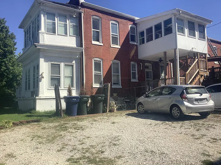 Parking area and trashcan area in the rear of the building. Each apartment gets one parking spot