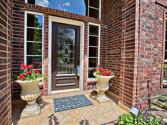 WELCOME to 3306 Candlelon Lane! Here you can see the tile entry that greets you, along with Low-E windows and lead glass front door.