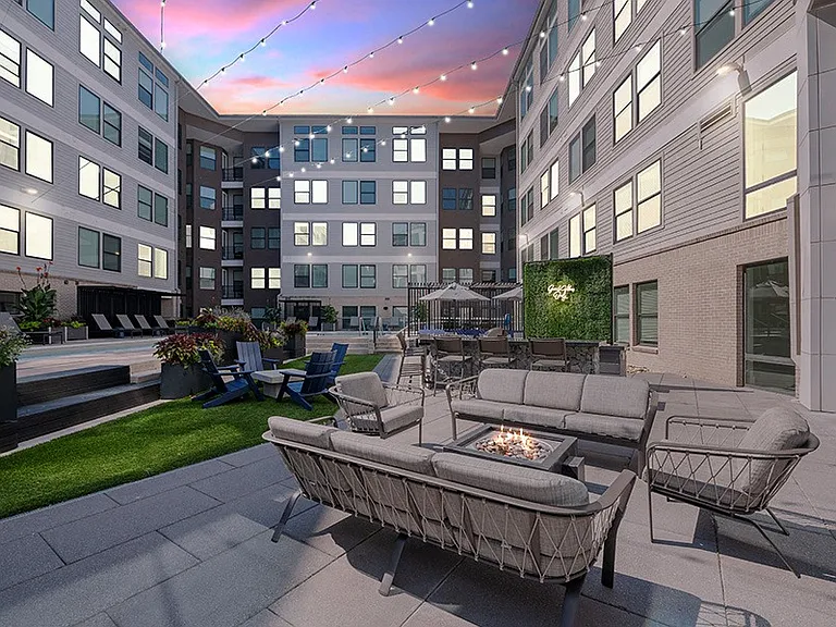 Poolside firepit area includes TV and grilling area
