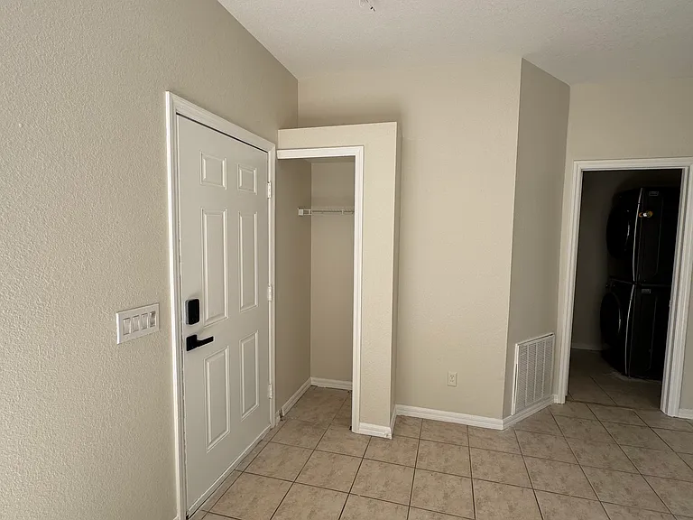 Entry way into large living room. Hall closet