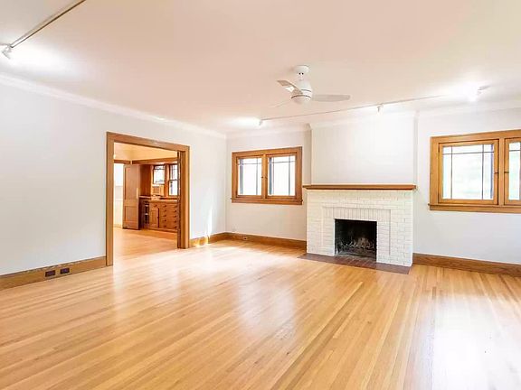 Living room with working fireplace and beautiful original hardwood floors.