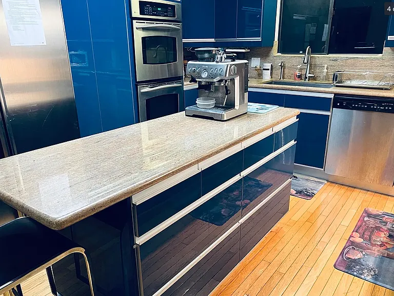 Kitchen with granite countertops and European-style cabinets and drawers. A brand-new refrigerator, dishwasher and garbage disposal have just been installed.