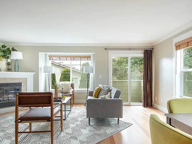 Second floor: south facing living room with fireplace and balcony