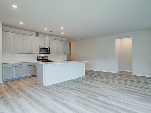The spacious kitchen island overlooks the dining area and great room.