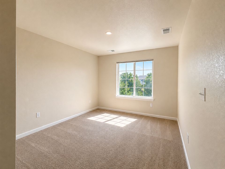 Unfurnished second-floor room with a large window, abundant natural light and neutral carpeting. Approx. 140 sq. ft. including closet. Digitally enhanced for presentation.