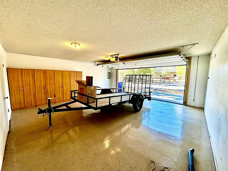 All new expoxy floors. New garage built in cabinets. Oversized two car garage. The trailer is 14' x 6' with plenty of room in front an back. Trailer not included.