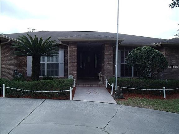 View of Entrance:  Dcor. painted front walk, off circle drive, landscaped areas both side of covered entry porch, trees, water h