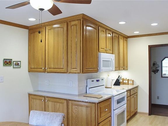 View of serving butler space. Oak raised panel cabinets with quartz counter tops. Range/oven and microwave are included.