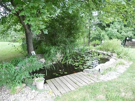 There is a decorative fish pond behind the deck.