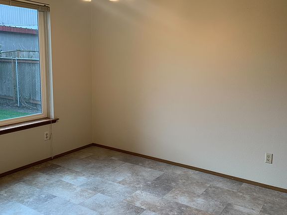 Den/dining space with view of backyard