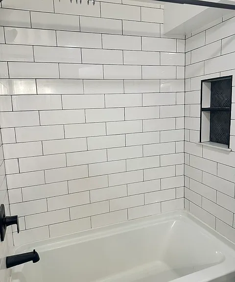 Fully renovated basement with a full bath including tub and shower.