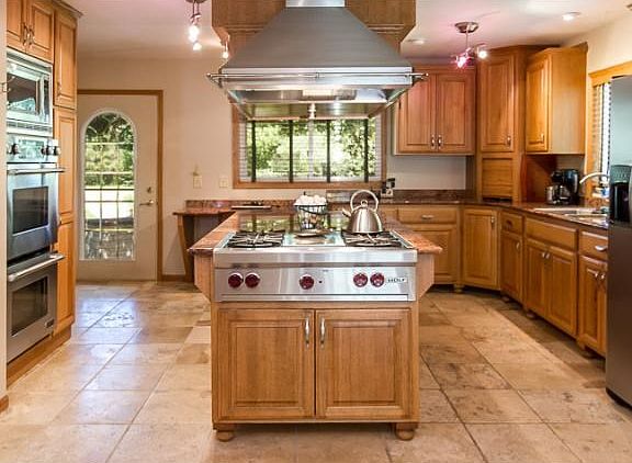 A closer look at the Wolf stovetop and hood, along with the stainless steel double oven, microwave a