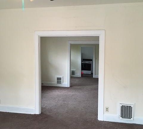 View from living room through all three rooms into kitchen.