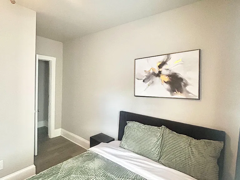 Furnished bedroom with a comfortable bed, ceiling fan, and nearby bath accessideal for restful downtime and easy routines.