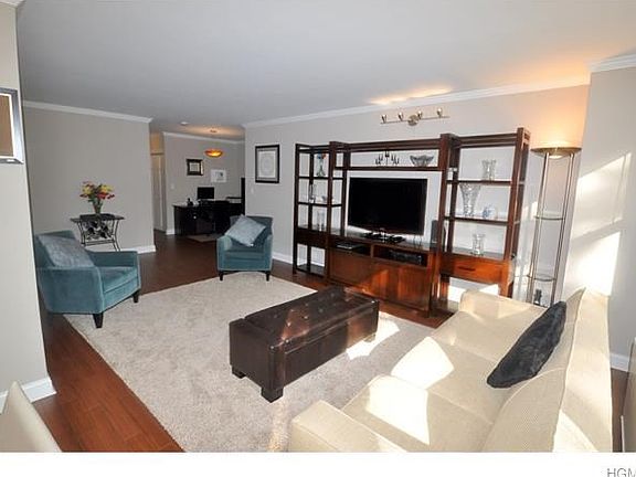 The Bright and sunny living room has crown molding and opens to both a dining area and entry foyer.  The living room is 23'-1" x 12'-0" and the dining area is 10'-6" x 8'-4", the entry foyer is an additional 12'-0" x 9'-1"