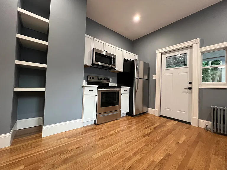 Eat-in kitchen with granite countertops and stainless steel appliances.