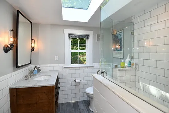 Top floor bathroom with standing shower and skylight