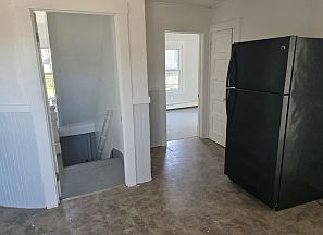 View from middle of kitchen down towards front door. You can also see into front bedroom.