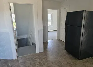 View from middle of kitchen down towards front door. You can also see into front bedroom.