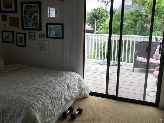 Bedroom with private patio on second floor overlooking greenbelt