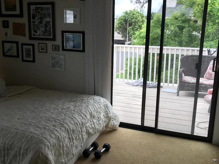 Bedroom with private patio on second floor overlooking greenbelt